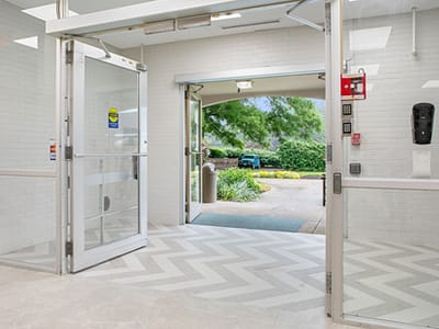 Interior entrance view with outdoor greenery visible.