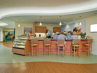 Residents enjoying a café space with people serving