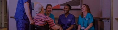 Staff and residents engaged in conversation and laughter.