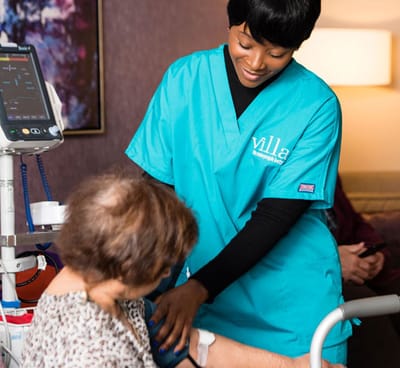 Nurse assisting a resident in a care setting.