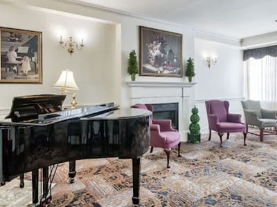 Common area with piano and seating