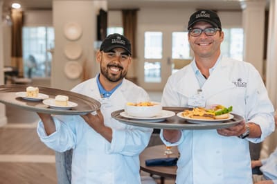 Chefs presenting meals in a dining area
