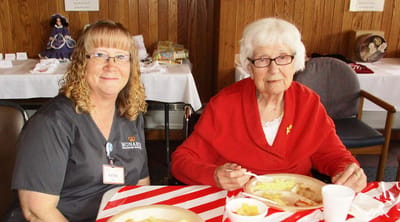 Staff member dining with a resident