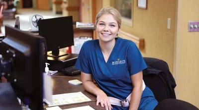 The Estates at Twin Rivers, Nursing Home in Anoka, MN — Receptionist at a senior living facility front desk