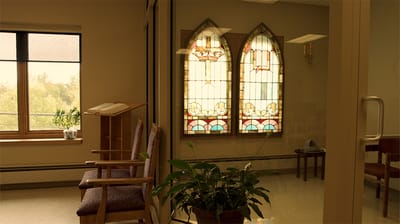Interior space with stained glass windows and seating