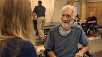 Resident engaging in conversation with staff member