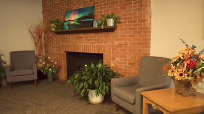 Cozy common area with seating and plants.