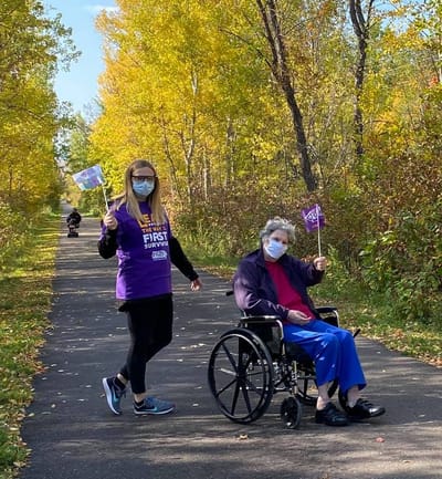 Resident and staff member enjoying a walk outdoors.
