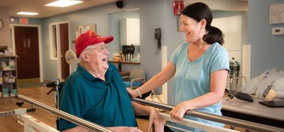 Staff member engaging with a resident in a common area.
