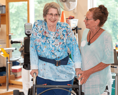 Resident interacting with staff in a common area.
