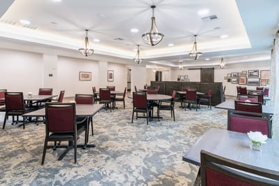 Dining area with tables and chairs for residents.