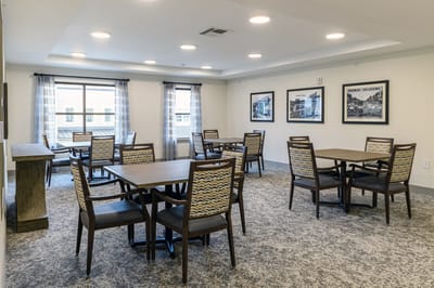 Dining area with tables and chairs.