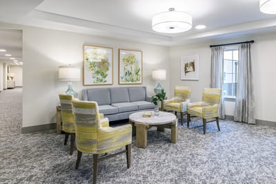 Common area with seating and decorative floral art