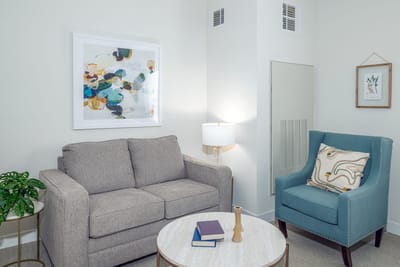 Cozy living area with a couch and art
