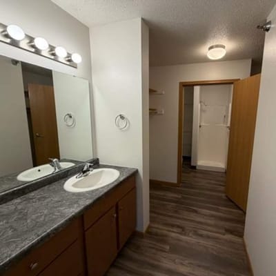 Clean bathroom with modern fixtures and lighting.