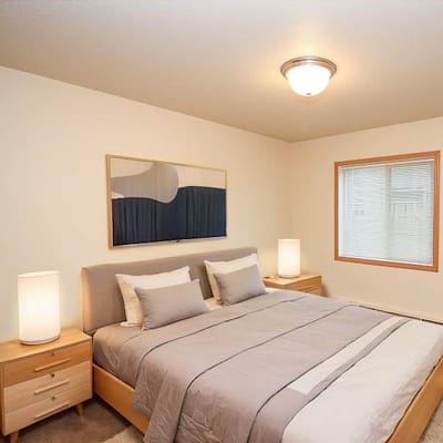 Cozy bedroom with modern decor and natural light.