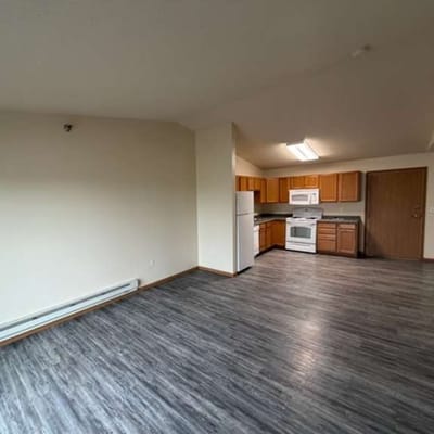 Empty kitchen area with appliances and wooden cabinets