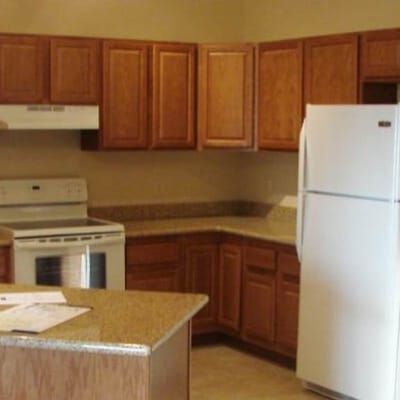 Kitchen area with wooden cabinets and appliances