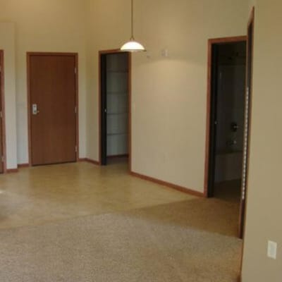 Empty room with beige walls and wooden doors
