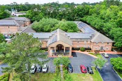 Aerial view of the Woodmont Senior Living facility with solar panels