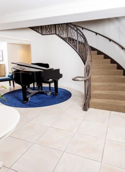 Elegant interior with a grand piano and staircase