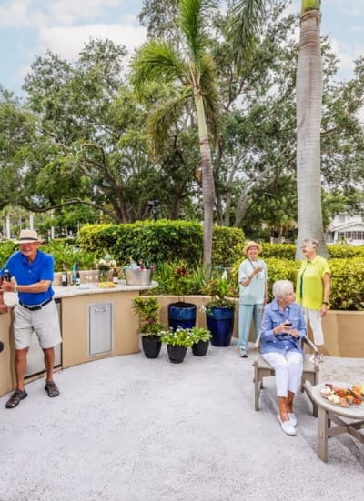 Residents enjoying refreshments in a garden setting