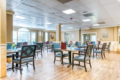 Bright and spacious common area with dining tables