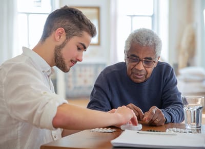 Arcadia Care Bloomington, Nursing Home in Bloomington, IL — Senior and young adult engaged in a game together