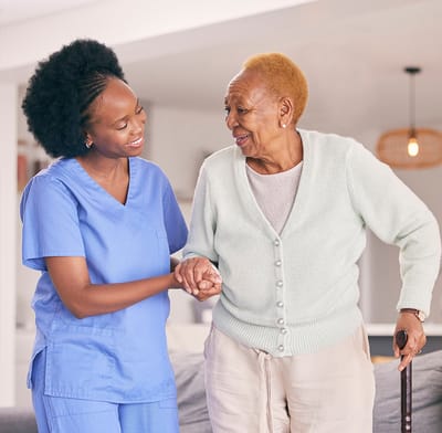 Arcadia Care Bloomington, Nursing Home in Bloomington, IL — Caregiver assisting an elderly woman in a home setting