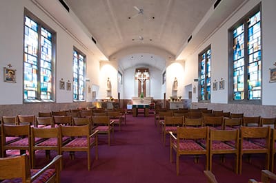 Interior view of a chapel with stained glass windows