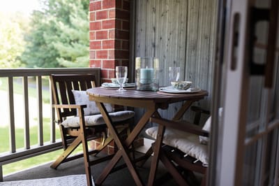 Outdoor balcony seating area with table and chairs