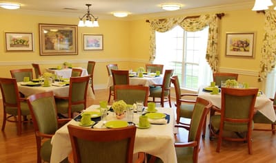 A bright dining room set with tables and chairs