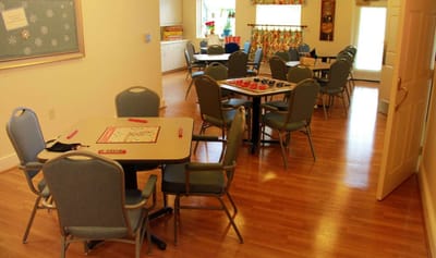 Bright common area with tables and chairs for activities