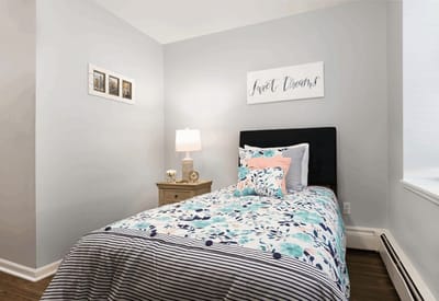 Cozy bedroom with floral bedding.
