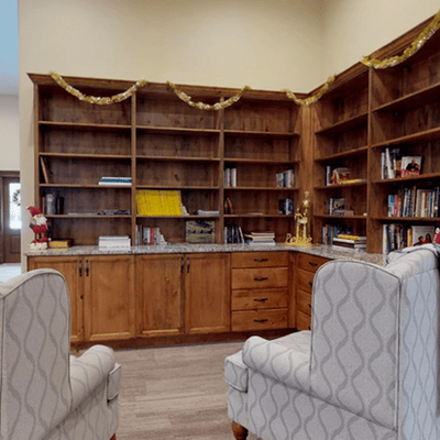 Cozy reading area with bookshelves and armchairs.
