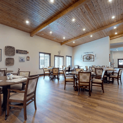 Dining area with wooden ceiling and tables