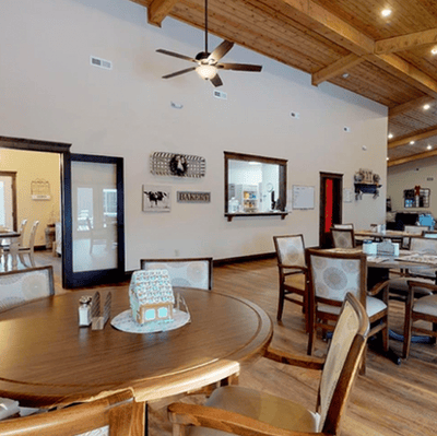 Dining area with wooden tables and chairs.