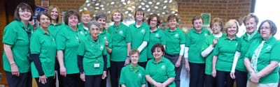 Group of staff members wearing green shirts