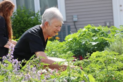 Senior resident engaging in gardening activity.