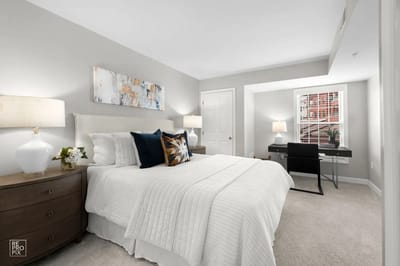 Cozy, well-furnished resident room in a facility.