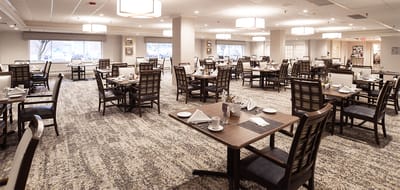 Dining room setup with tables and chairs.