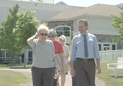 Residents and staff walking outside together
