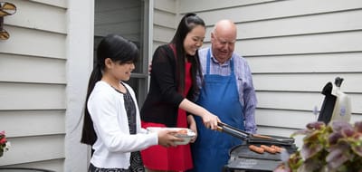 Residents and staff grilling outdoors together