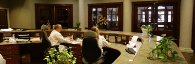 Reception area with staff attending to tasks.