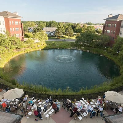 Residents enjoying a serene outdoor pond area.