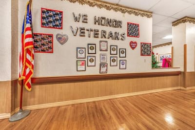 Wall honoring veterans with photos and awards.