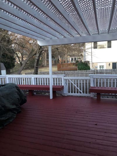 Patio area with benches and wooden flooring.