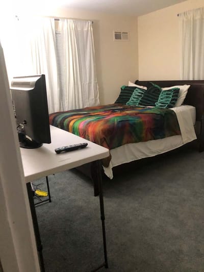 Private resident room with bed and TV.