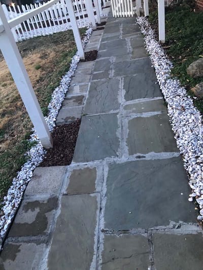 Paved pathway leading to a facility entrance.