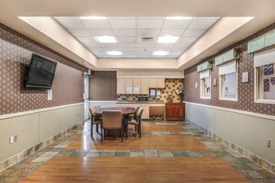 Modern common area with dining table and kitchenette.